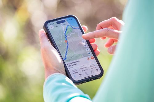 Hiker using the Macs App to check their route